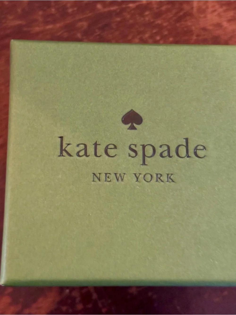 kate spade gold-tone item in lime green box